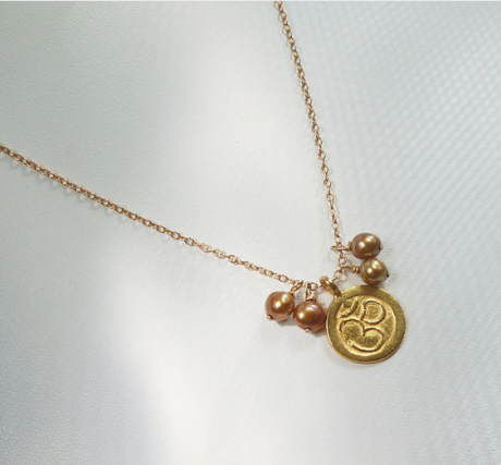 Gold Ohm Necklace with pearls.